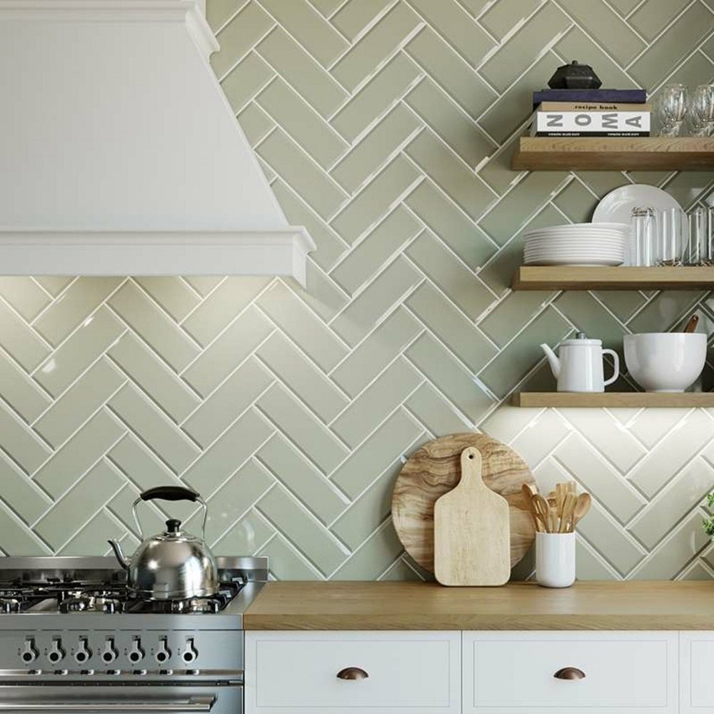 Applying adhesive before setting kitchen wall tiles