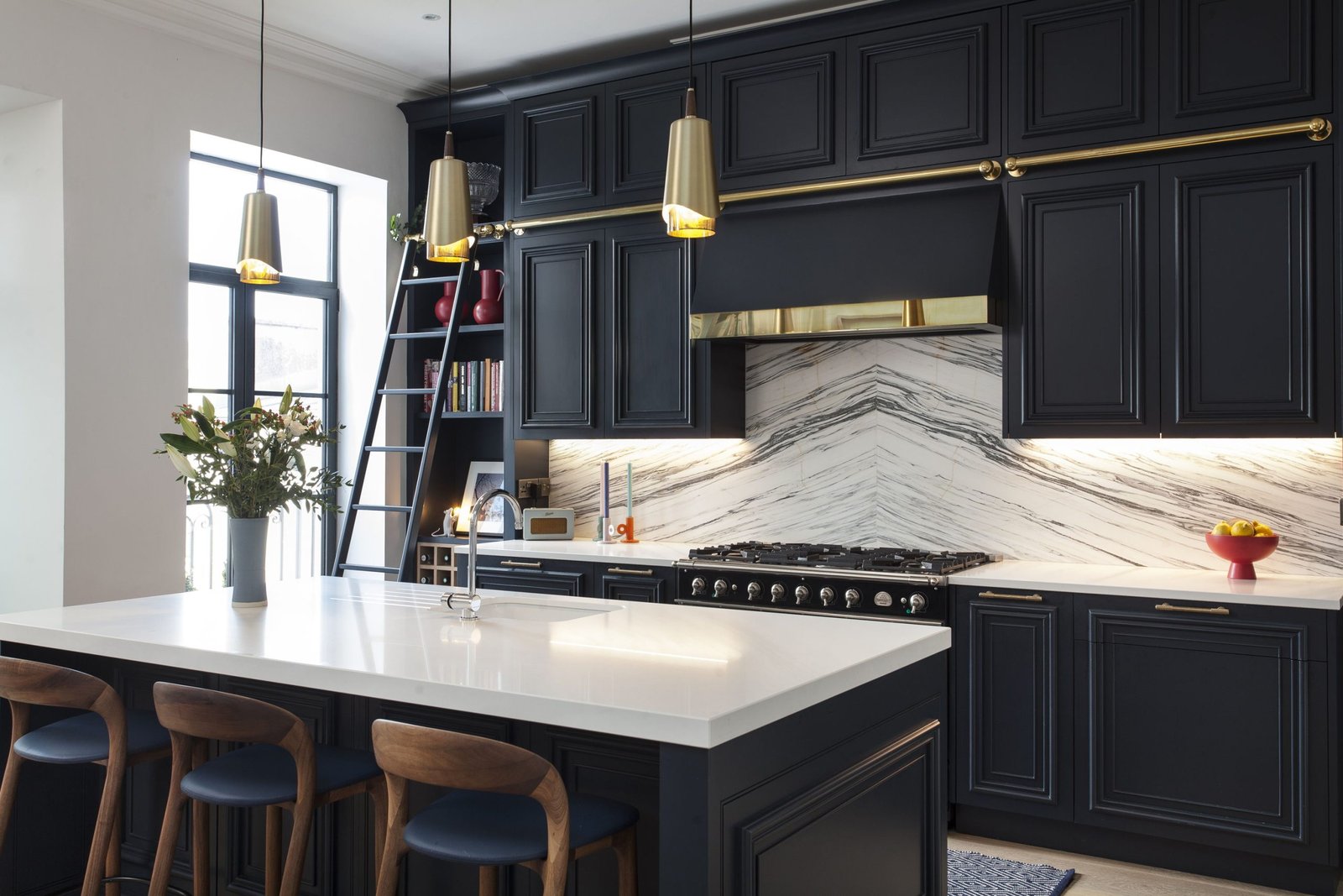 Elegant kitchen featuring navy units with light taupe walls
